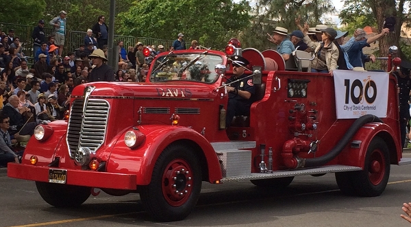 The Davis Town Council riding in a vintage firetruck.