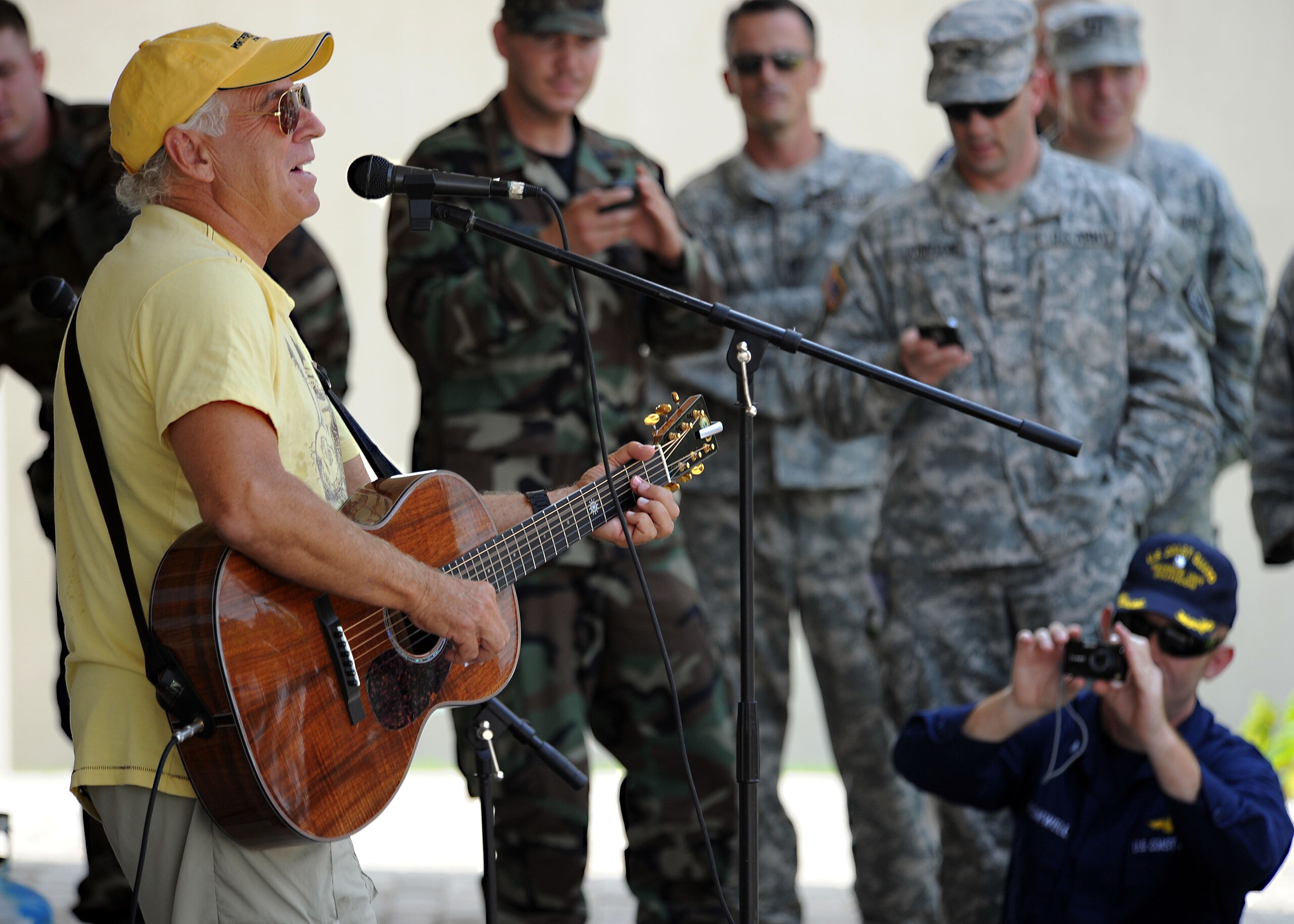 Jimmy Buffet playing guitar and singing